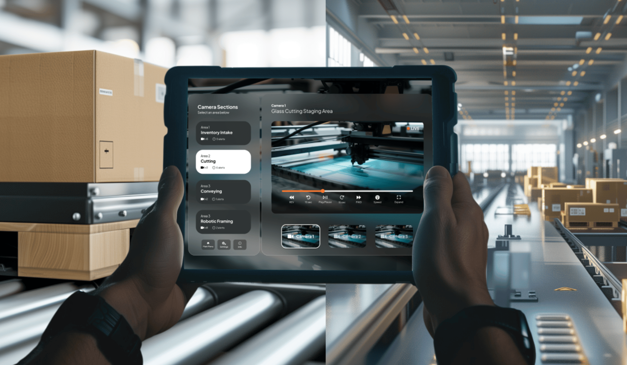 Person holding a tablet showing a live feed of a production line in a warehouse. The screen displays camera options and a video of a machine cutting materials. Background shows conveyor belts and stacked boxes under bright lighting.