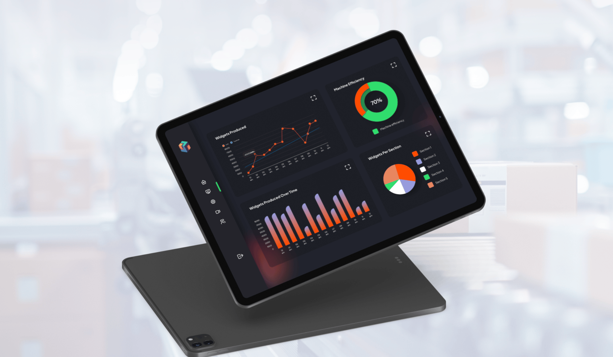 A tablet displaying colorful data visualizations, including line and bar graphs and pie charts, showing analytics. The background is blurred, suggesting a manufacturing environment.